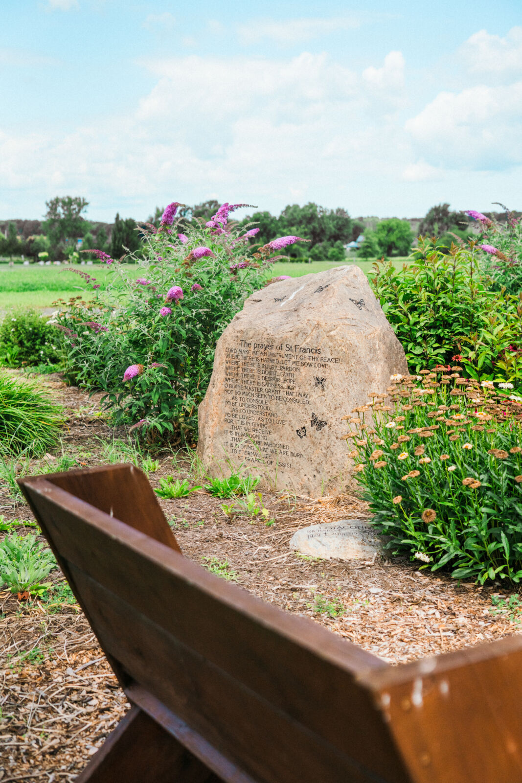 Green Burial area with a bench and wooden bridge