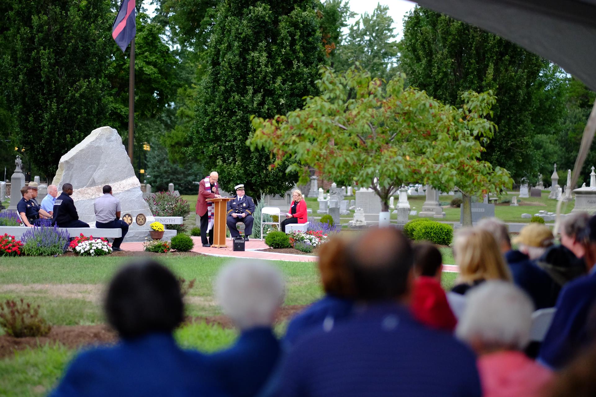 service for a first responder in front of a large monument