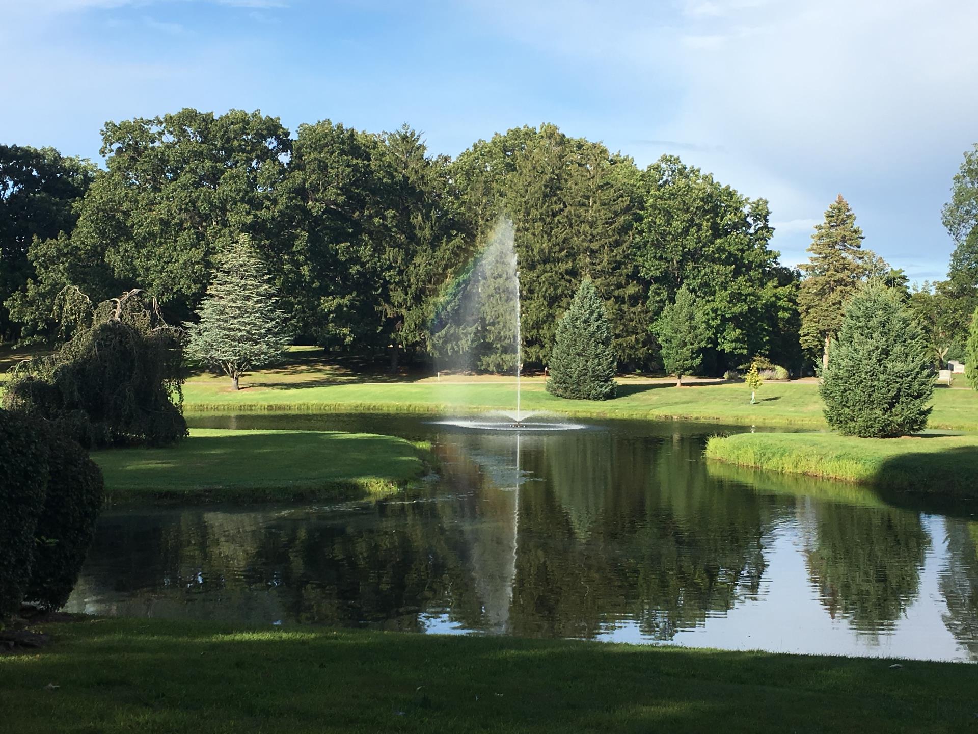 image of the green burial section featuring a pond with a fountain